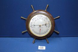 A Weather Master barometer in ships wheel style frame, 10" diameter.