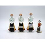 A set of three Hollohaza figures of young girls in traditional dress and one other.