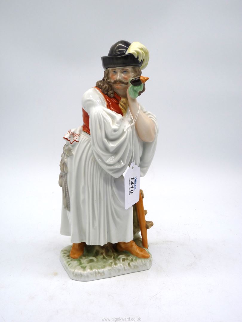 A Herend hand painted figure of a man in traditional dress leaning on a stick with a pipe in his