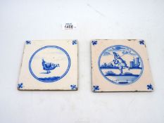 Two antique Delft blue and white tiles decorated with a chicken and an angler respectively,