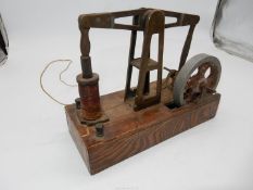 A fascinating electro-magnetically driven miniature Beam Engine mounted on an Oak base and having