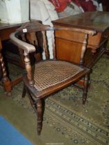 A darkwood framed bow back Saloon type Chair having carved detail to the top rail,