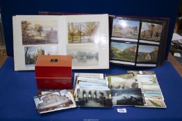 Two albums and a plastic box of postcards including flooded landscapes, Cathedrals, etc.