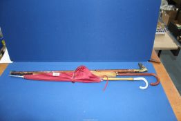 Two vintage ladies umbrellas and a three piece walking stick with brass horse head handle.