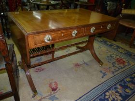 A Mahogany Sofa Table having a pair of frieze drawers and standing on side supports united by a