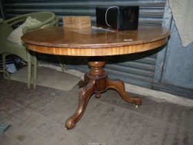 A snap-top Table having a turned pillar and three carved detail splay feet,