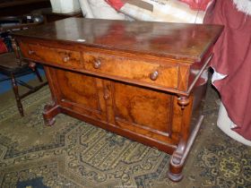 A circa 1900 Walnut and other woods Sideboard having opposing doors to the cupboard to the base,