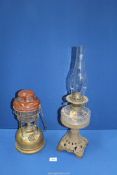 A Tilley lamp and an Oil lamp with glass reservoir.