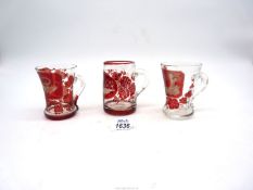 Three antique Bohemian ruby red etched cups including; one depicting two birds in a woodland scene,