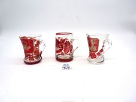 Three antique Bohemian ruby red etched cups including; one depicting two birds in a woodland scene,