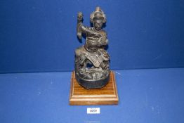 A Chinese Qing dynasty carved wooden figure, probably Tsai Shen Yeh (God of Wealth),
