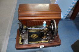 A wooden cased Singer hand sewing machine, no: K1242870.