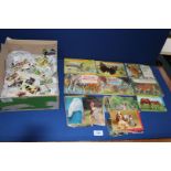 A box of animal related cigarette cards and postcards.