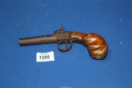 A very old Percussion muzzle loading Pistol having a top hammer, the action being scroll-engraved,