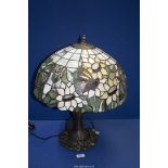 A Tiffany style table Lamp and large shade with butterfly and flower decoration, 21'' high.