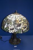 A Tiffany style table Lamp and large shade with butterfly and flower decoration, 21'' high.