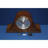 An Enfield wooden cased chiming mantle clock made for Dubros Stores with key and pendulum.