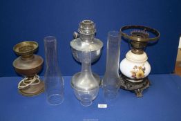 Three oil Lamps including white metal, ceramic, etc , with glass chimneys.