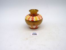 A Moorland Trial vase with gold lustre bands and red, orange and yellow triangle pattern, 4" tall.