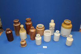 A quantity of salt glazed pots including 'Facey & Son Wholesale Bottles Abergavenny', etc.