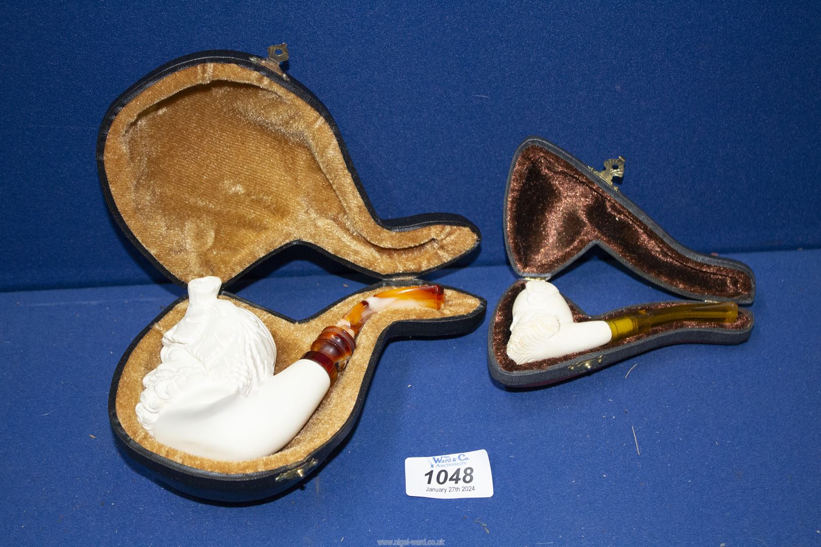 Two cased unsmoked meerschaum Pipes, the larger one carved as Dionysus, God of Wine,