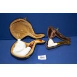 Two cased unsmoked meerschaum Pipes, the larger one carved as Dionysus, God of Wine,
