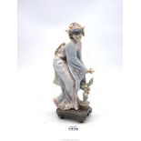 A Lladro figure of an oriental girl with garland in her hair and flower in her hand,