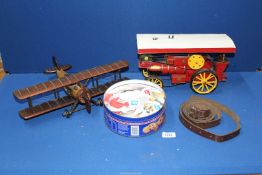 A model of a steam engine, wooden Bi-plane, leather strap and a small quantity of stamps.
