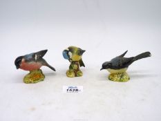 Three Beswick bird figures, Blue Tit (992), Grey Wagtail (1041, chip to tail) and Bullfinch (1042).