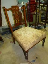 A good quality mixed woods low side Chair having intricate inlaid details to the backrest,