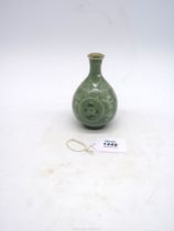 A Celadon vase with bird and floral detail, 5" tall.
