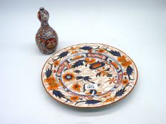 A large oriental charger, blue and orange design, plus an oriental vase, orange and blue flowers.