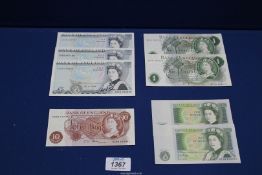 Three £5 notes, four £1 notes (two types) and one 10 shilling note.