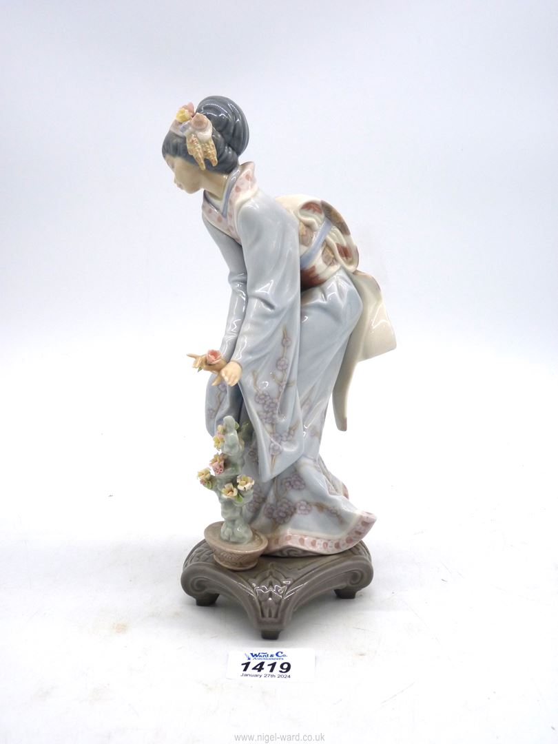 A Lladro figure of an oriental girl with garland in her hair and flower in her hand, - Image 2 of 3