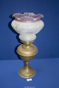 A copper oil Lamp with pink edged glass shade, 19 1/2'' tall, a/f.