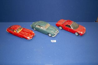Three 1/18 scale model cars including Maisto Thunderbird and 1959 Mk II Jaguar ad a Burago 1961