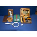 A small tray of ephemera namely an unused men's grooming cased set, a travelling shaving set,