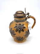 A Doulton Lambeth globular stoneware jug with applied floral motifs, silver hinged lid, London 1871,