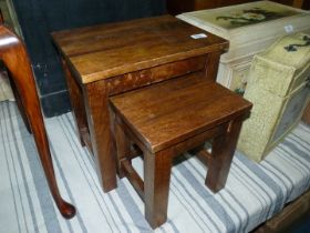 A nest of two Eastern hardwood occasional Tables standing on square legs,