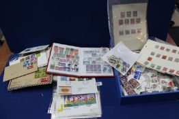 A box of loose stamps, First Day covers and an album.