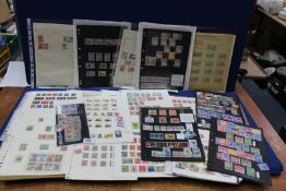 A quantity of British Commonwealth stamps and four other postcards.