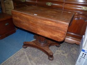 A 19th century Mahogany dropleaf centre Table standing on a turned and faceted tapering pillar with