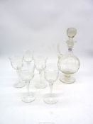 An etched claret jug with five matching wine glasses with twist stems.