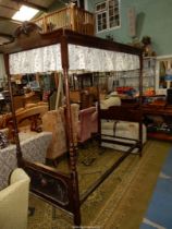 A dark Oak framed four Poster single Bedstead, with turned columns,