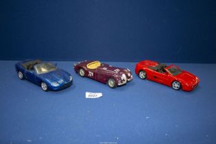 Three 1/24 scale model cars including Maisto Ferrari F355 and Jaguar XK8 plus Burago 1948 Jaguar