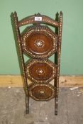 A three tier folding Cake Stand having decorative inlaid detail.