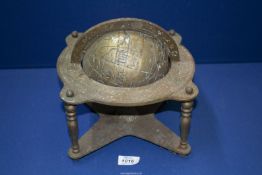 A heavy brass Globe in frame, with signs of the zodiac, 9'' square x 9'' high, need some attention.