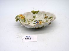 A late 19th century Cantagalli shaped dish painted with flowers and with grotesque mask handle in