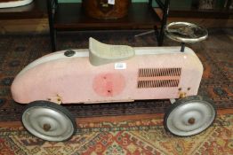 A child's tin plate toy car.
