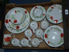 A quantity of Royal Worcester 'Poppies' teaware including cups and saucers and jugs, etc.